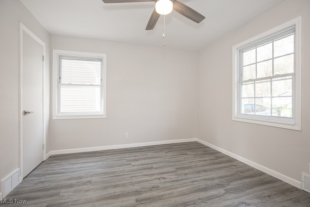 223 Beck Road Avon Lake, OH 44012 - Photo 10 of 29 Bedroom with a ceiling fan, visible vents, wood finished floors, and baseboards