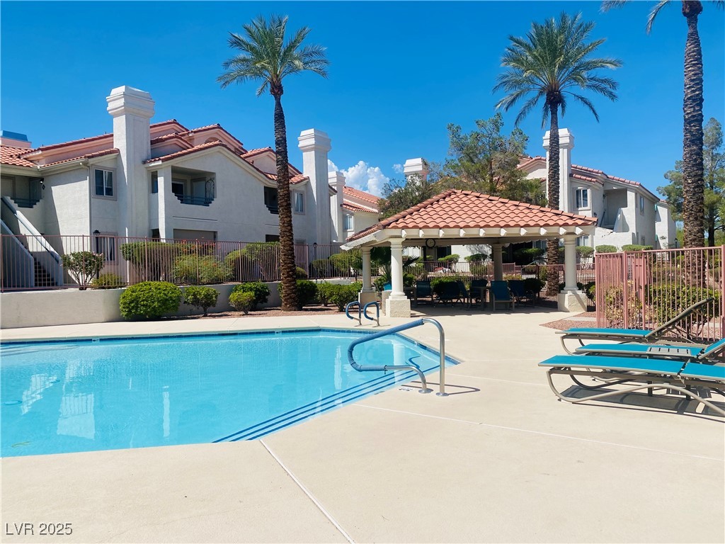 717 Wheat Ridge Lane, Unit 103 Las Vegas, NV 89145 - Photo 14 of 15 Community pool featuring a patio area, a gazebo, and a residential view