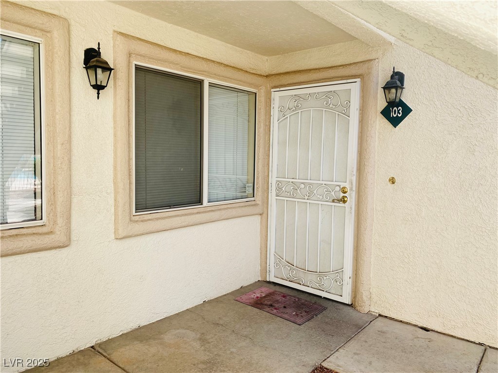 717 Wheat Ridge Lane, Unit 103 Las Vegas, NV 89145 - Photo 3 of 15 Property entrance with stucco siding