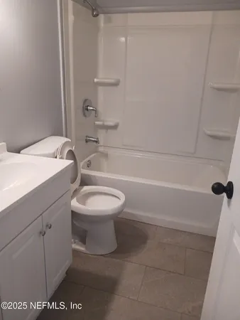 a bathroom with a toilet a sink and bathtub