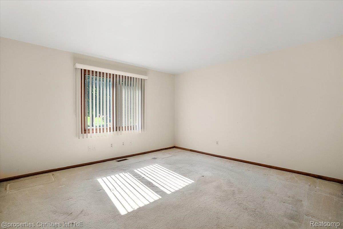 37224 Chesapeake Road Farmington, MI 48335 - Photo 42 of 50 Neutral wall colors with wood baseboards and a large window featuring vertical blinds