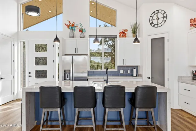 a view of a dining room with furniture and a chandelier