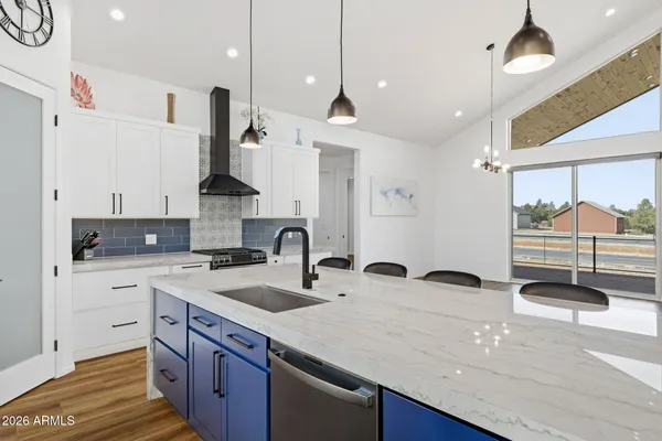 a kitchen with stainless steel appliances granite countertop a sink a stove and a refrigerator