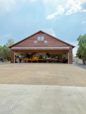 a kitchen with granite countertop a sink appliances cabinets and furniture