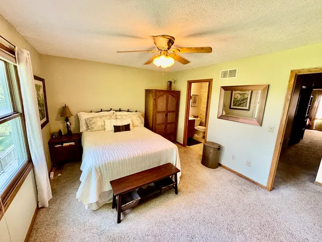 a bedroom with a bed closet and a large window