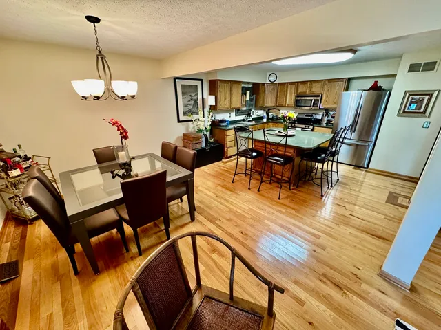 a living room with furniture dining table and wooden floor