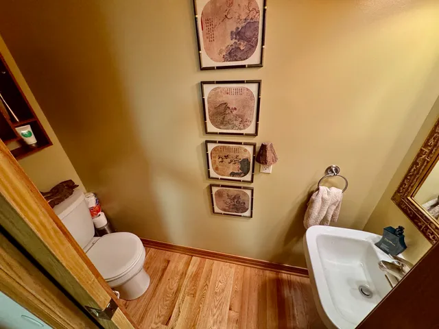 a bathroom with a toilet and a mirror