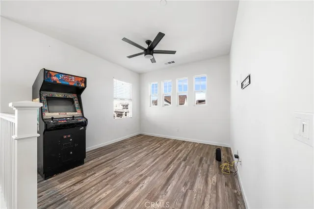 a view of a white house with a yard and sitting area