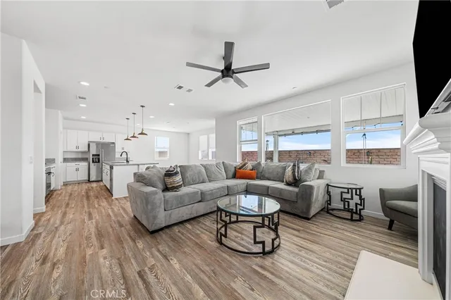 a kitchen with a sink a counter top space stainless steel appliances and a center island