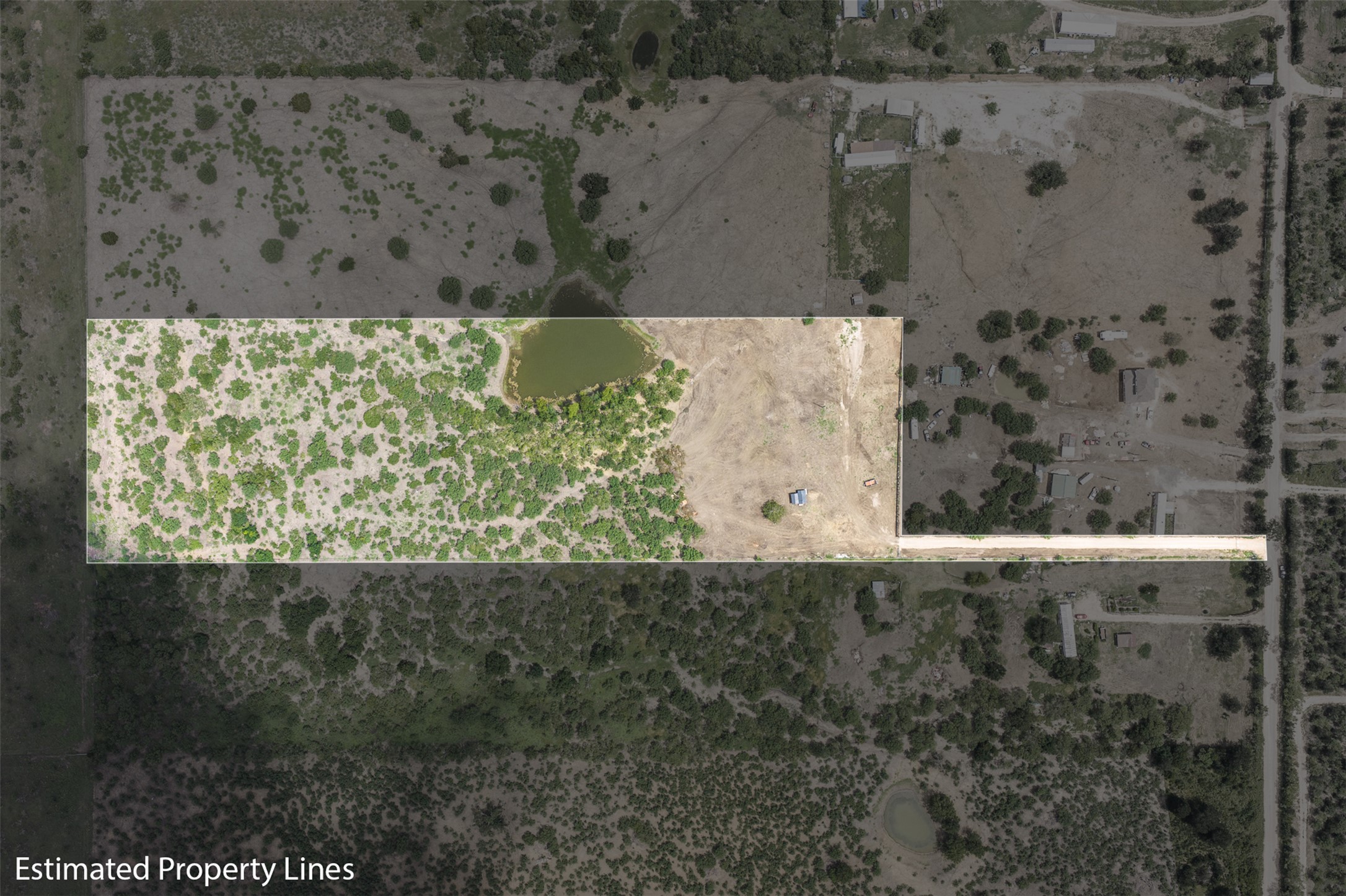 3315 Dry Creek Road Lockhart, TX 78644 - Photo 4 of 26 Aerial view of a verdant property showcasing a pond and ample open land.