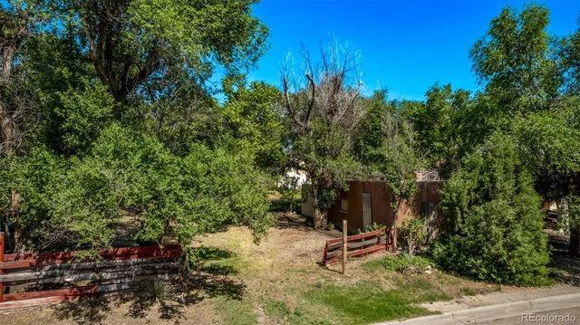 an aerial view of a house with yard