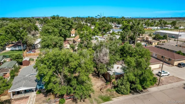 an aerial view of a house with yard