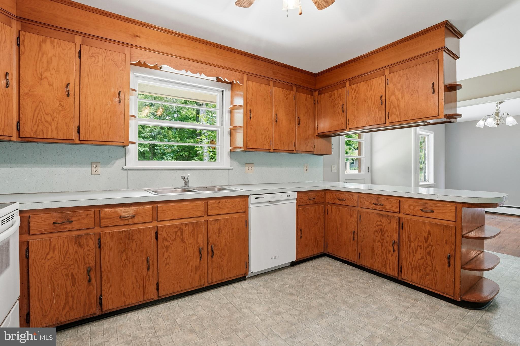 486 Derstine Road Hatfield, PA 19440 - Photo 15 of 53 a kitchen with stainless steel appliances granite countertop wooden cabinets a sink and a window