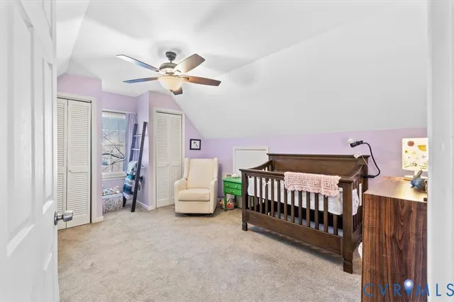 a view of bedroom with furniture and a chandelier fan