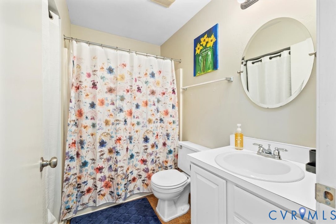 12505 Mandolin Drive Midlothian, VA 23113 - Photo 14 of 26 a bathroom with a sink a toilet and a mirror