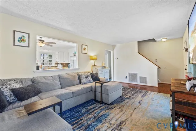 a living room with furniture and wooden floor