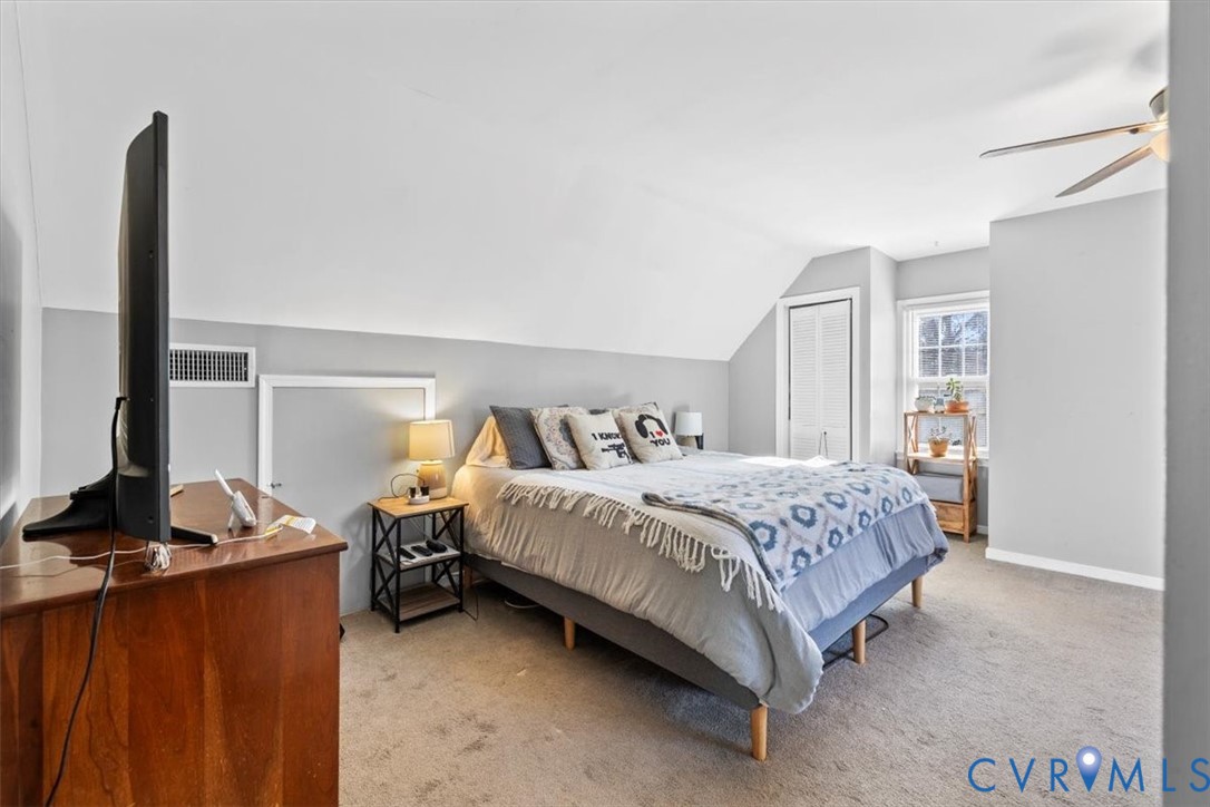 12505 Mandolin Drive Midlothian, VA 23113 - Photo 8 of 26 a bedroom with a bed and a flat tv screen on the dresser