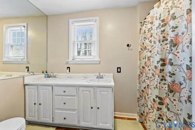 a bathroom with double sink and a mirror
