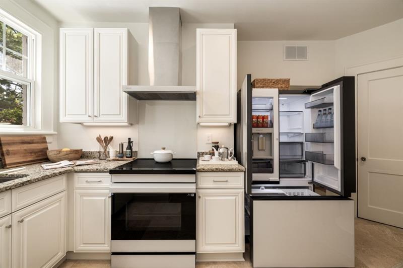 a kitchen with stainless steel appliances granite countertop a stove and a sink