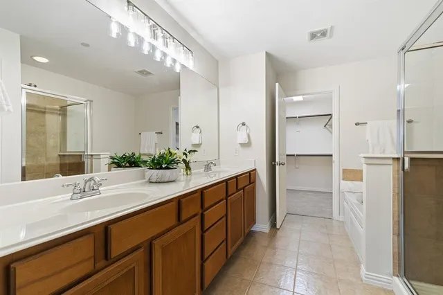 a spacious bathroom with a double vanity sink shower and a mirror