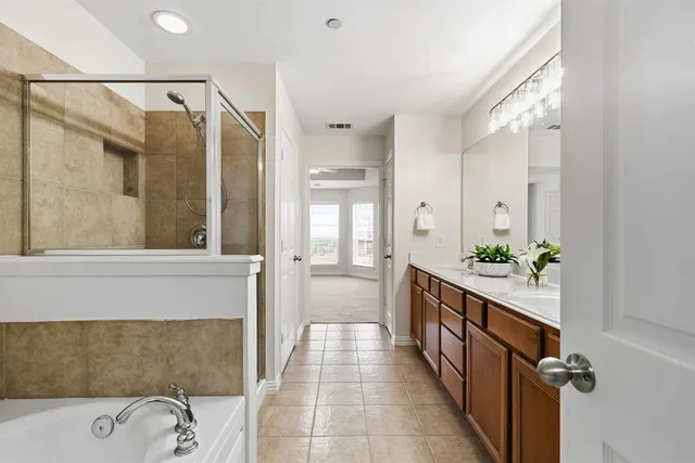 a bathroom with a bathtub and shower