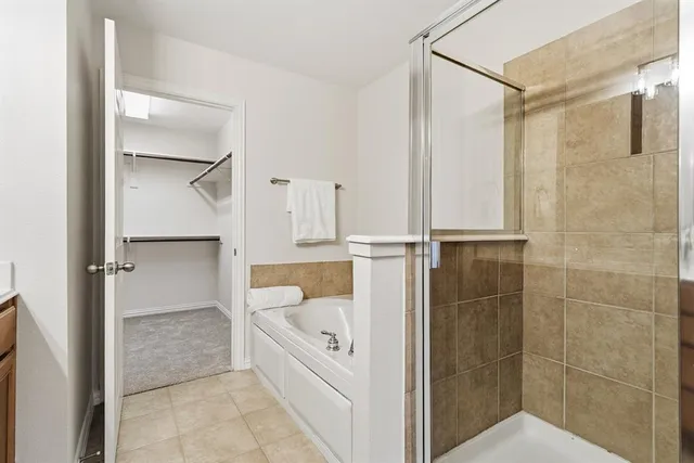 a bathroom with a bathtub and a shower