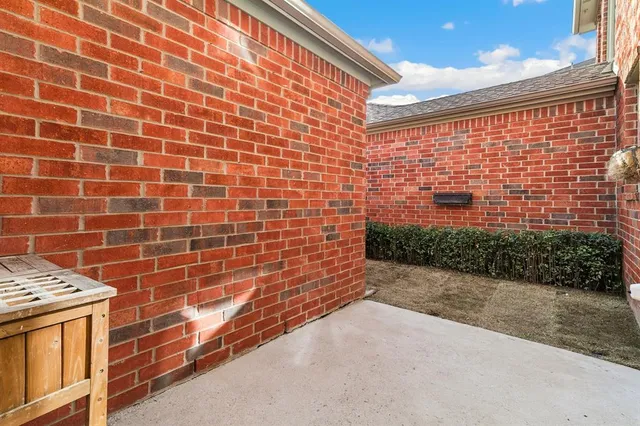 a view of a backyard with a chair and a fireplace
