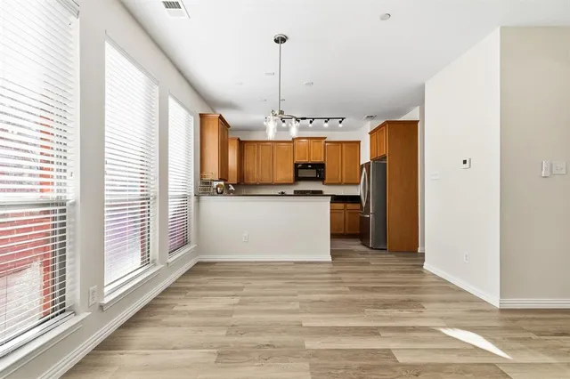 a view of a kitchen with a sink microwave and cabinets
