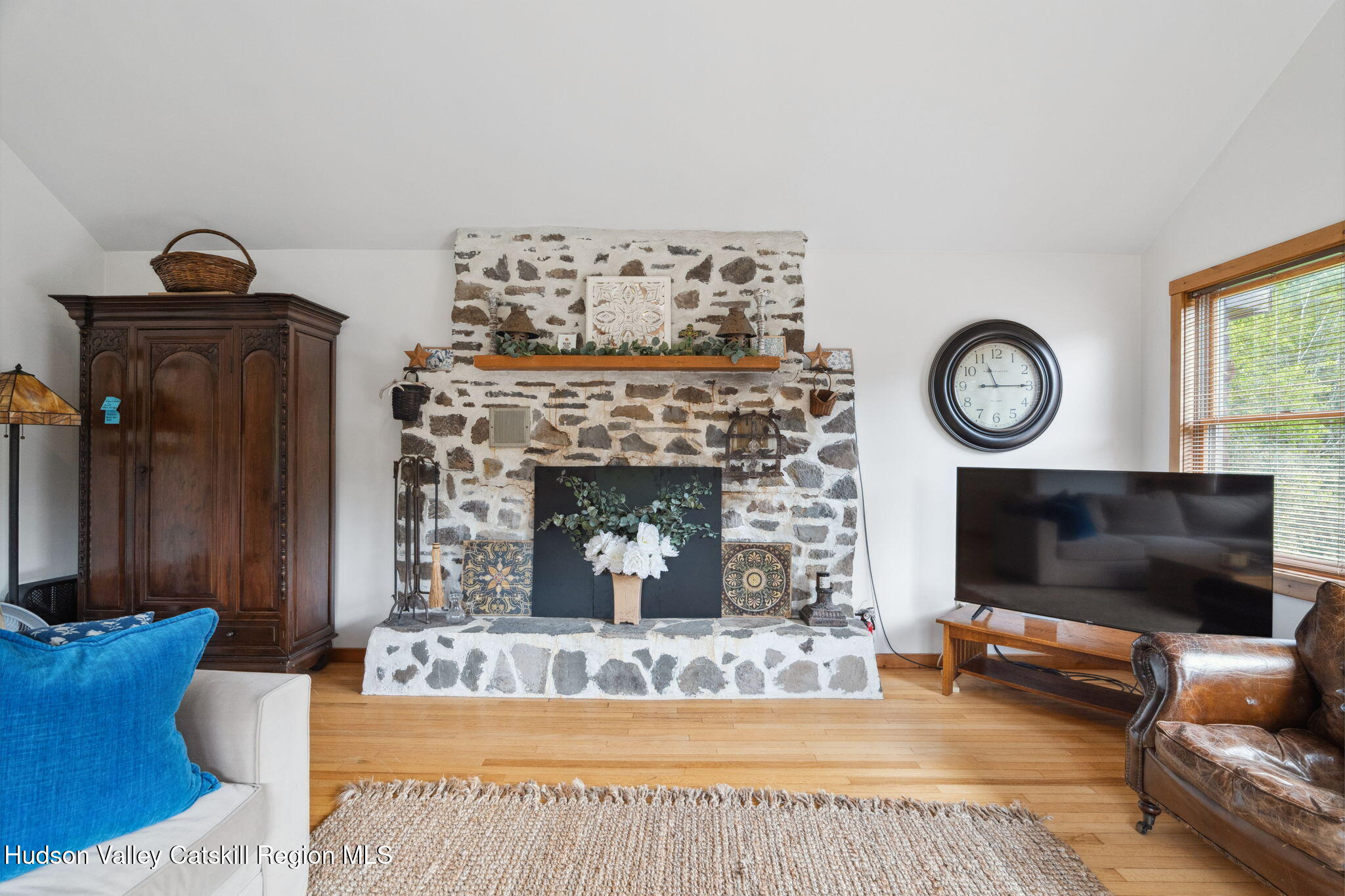 552 Bear Kill Road Gilboa, NY 12076 - Photo 32 of 63 a living room with furniture a flat screen tv and a fireplace