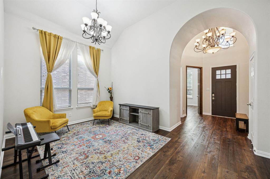 1013 Knoxbridge Road Forney, TX 75126 - Photo 15 of 39 a bedroom with a bed and a chandelier