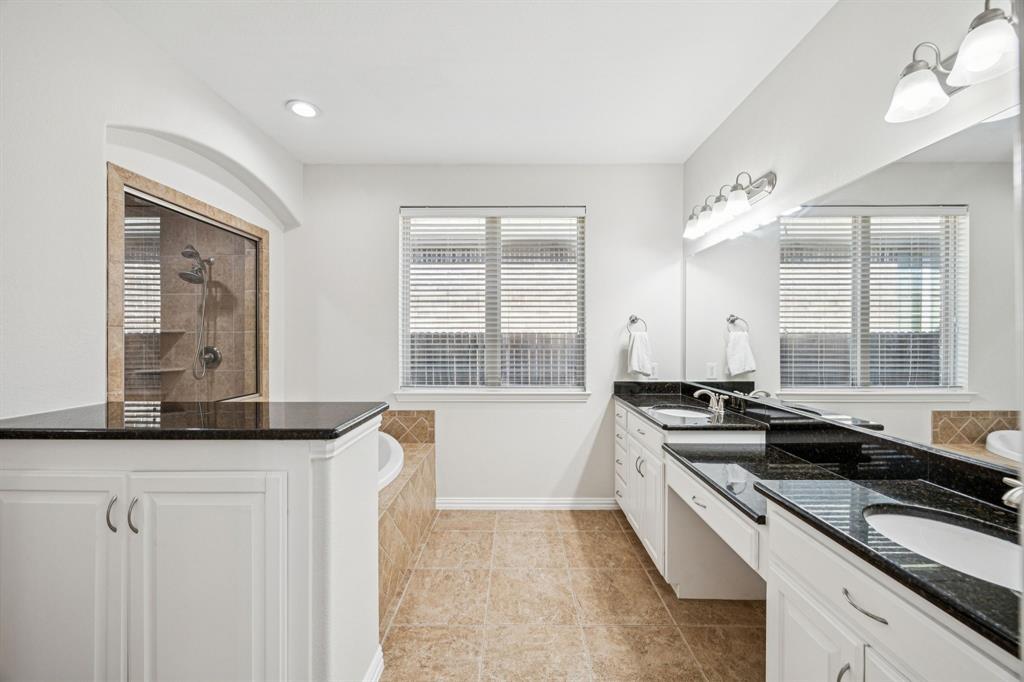 1013 Knoxbridge Road Forney, TX 75126 - Photo 19 of 39 a kitchen with granite countertop a sink and a white wooden cabinets