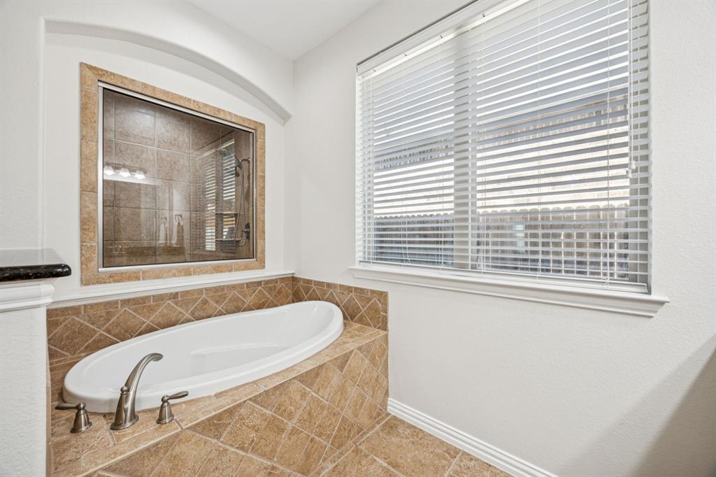 1013 Knoxbridge Road Forney, TX 75126 - Photo 20 of 39 a bathroom with a tub and a window