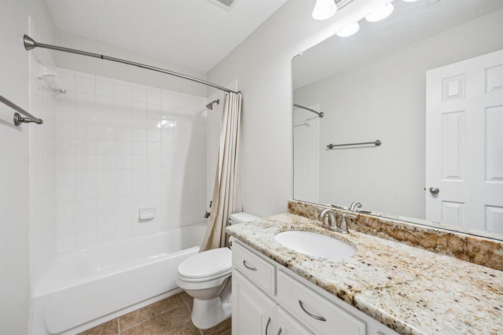 1013 Knoxbridge Road Forney, TX 75126 - Photo 27 of 39 a bathroom with a granite countertop sink toilet and shower