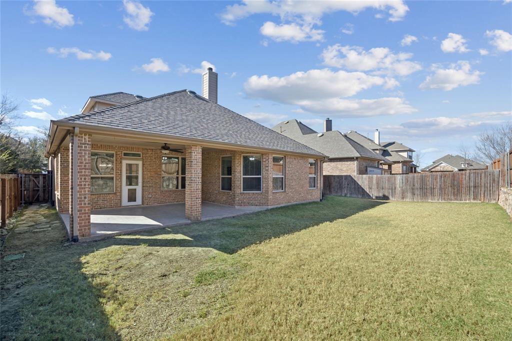 1013 Knoxbridge Road Forney, TX 75126 - Photo 30 of 39 a front view of a house with a yard and garage