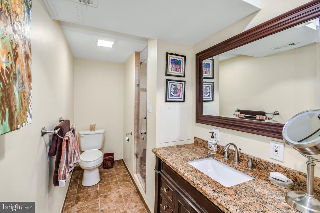 111 Ashmead Road Cheltenham, PA 19012 - Photo 13 of 18 a bathroom with a granite countertop sink mirror vanity and toilet