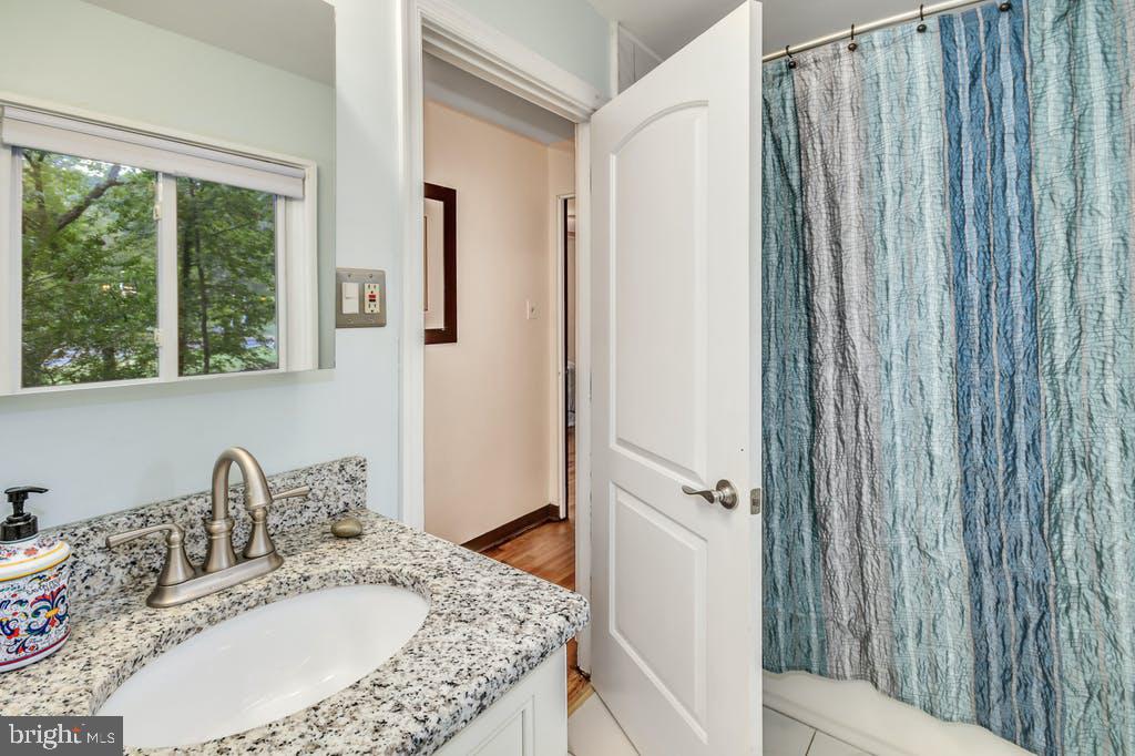 111 Ashmead Road Cheltenham, PA 19012 - Photo 16 of 18 a bathroom with a granite countertop sink and a mirror