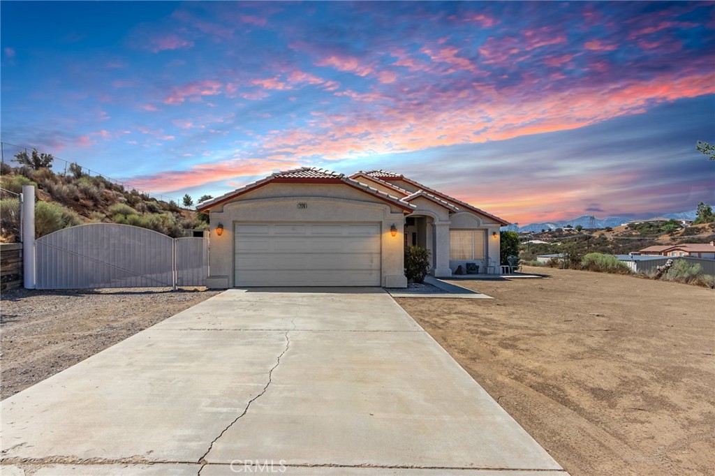 7170 Joshua Road Oak Hills, CA 92344 - Photo 13 of 59 a front view of a house with a yard and mountain view