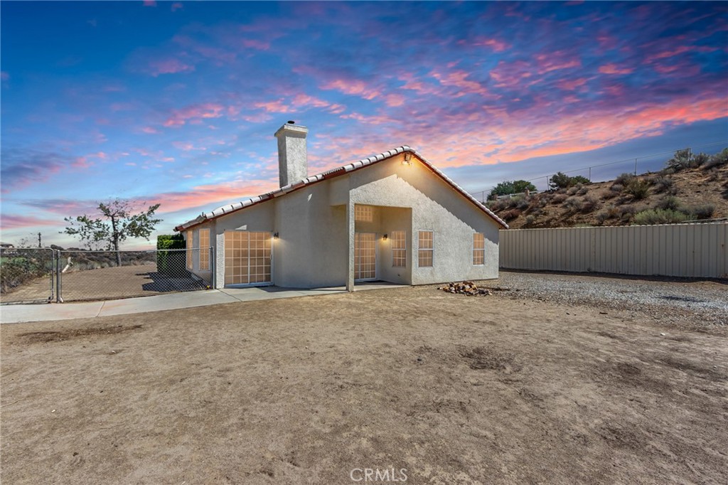 7170 Joshua Road Oak Hills, CA 92344 - Photo 14 of 59 a view of a house with a backyard