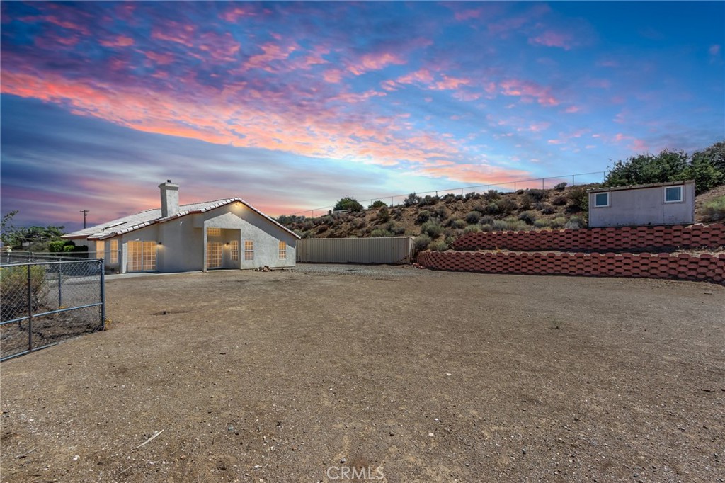7170 Joshua Road Oak Hills, CA 92344 - Photo 16 of 59 a front view of a house with a yard