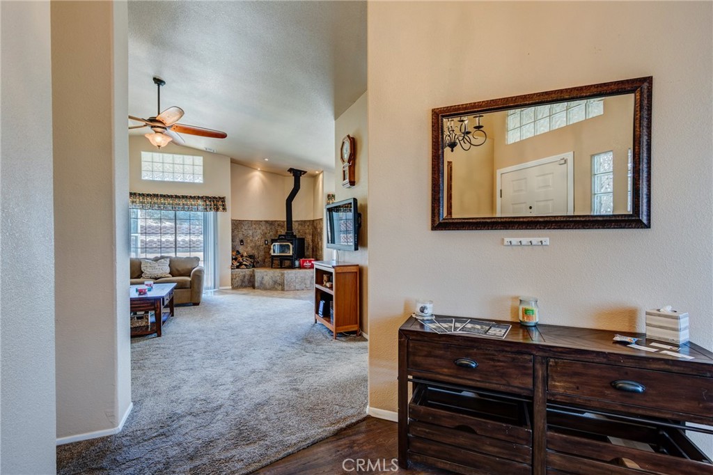 7170 Joshua Road Oak Hills, CA 92344 - Photo 22 of 59 a living room with furniture and a flat screen tv