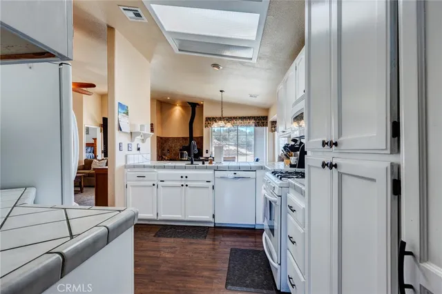 a kitchen with stainless steel appliances granite countertop a sink and cabinets