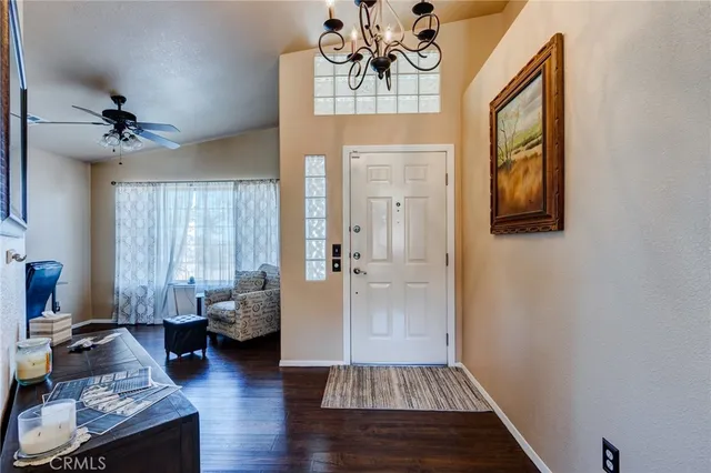 a living room with furniture a large window and a fireplace