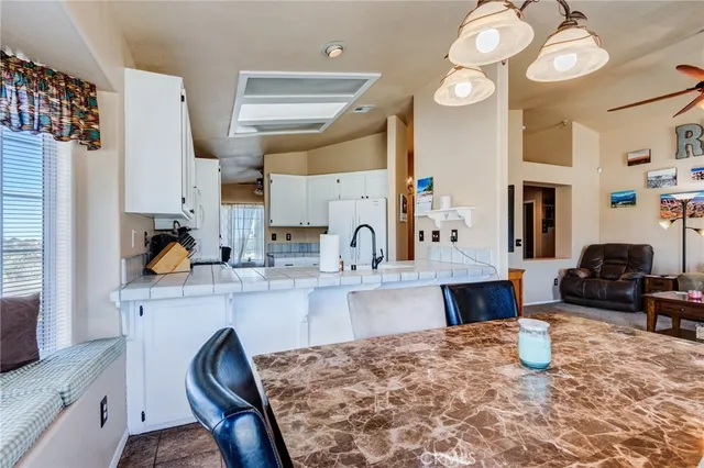 a living room with furniture a dining table and a flat screen tv