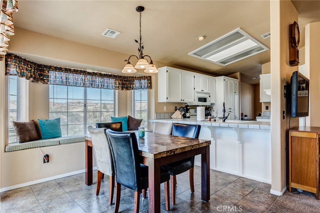 7170 Joshua Road Oak Hills, CA 92344 - Photo 37 of 59 a view of a dining room with furniture window and outside view
