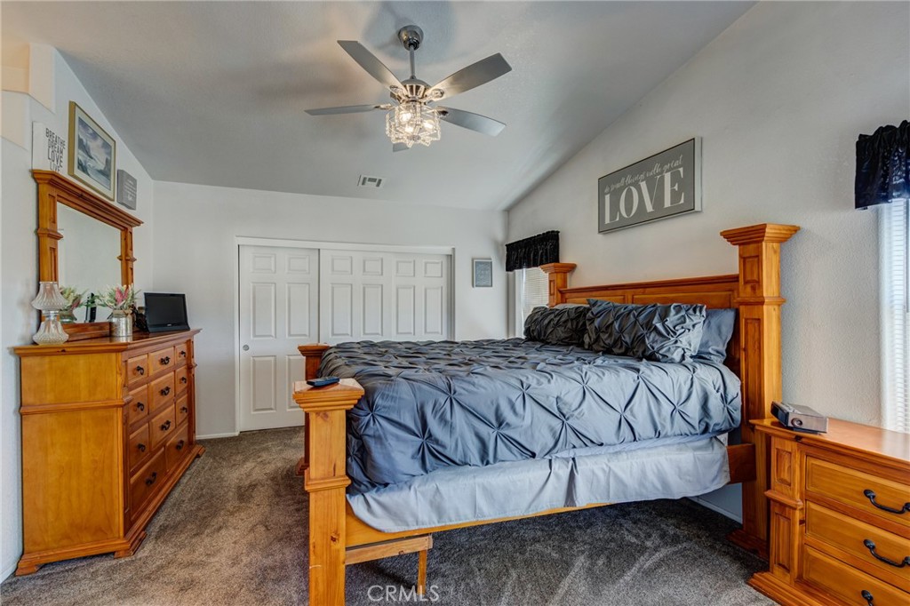 7170 Joshua Road Oak Hills, CA 92344 - Photo 40 of 59 a bedroom with a bed and wooden floor