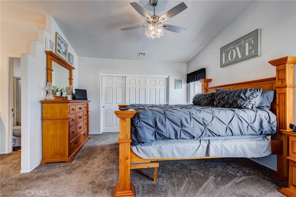 7170 Joshua Road Oak Hills, CA 92344 - Photo 45 of 59 a bedroom with a bed and a chandelier