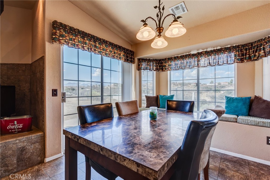 7170 Joshua Road Oak Hills, CA 92344 - Photo 46 of 59 a view of a dining room with furniture and a large window