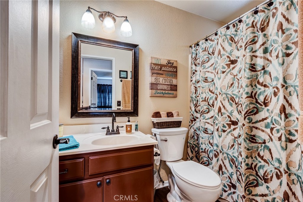 7170 Joshua Road Oak Hills, CA 92344 - Photo 50 of 59 a bathroom with a sink toilet and mirror