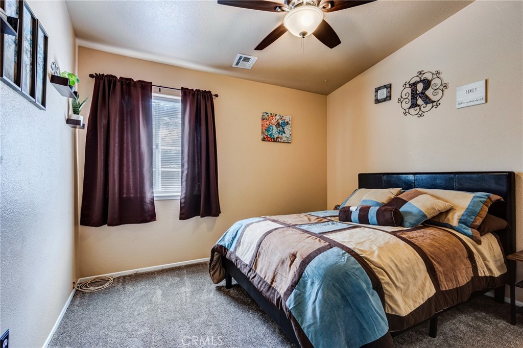7170 Joshua Road Oak Hills, CA 92344 - Photo 53 of 59 a bedroom with bed and window
