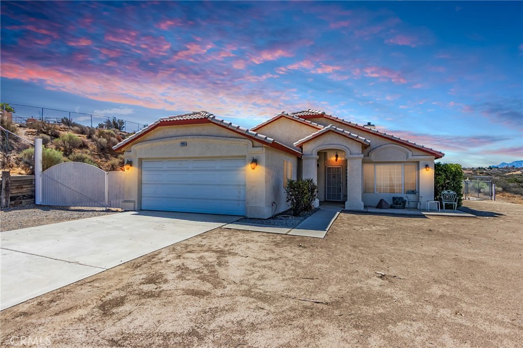 7170 Joshua Road Oak Hills, CA 92344 - Photo 8 of 59 a front view of a house with a yard